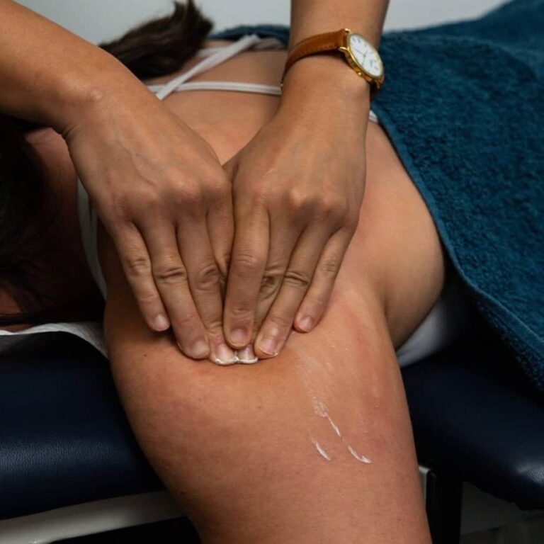 Physiotherapist providing hands-on treatment for shoulder pain