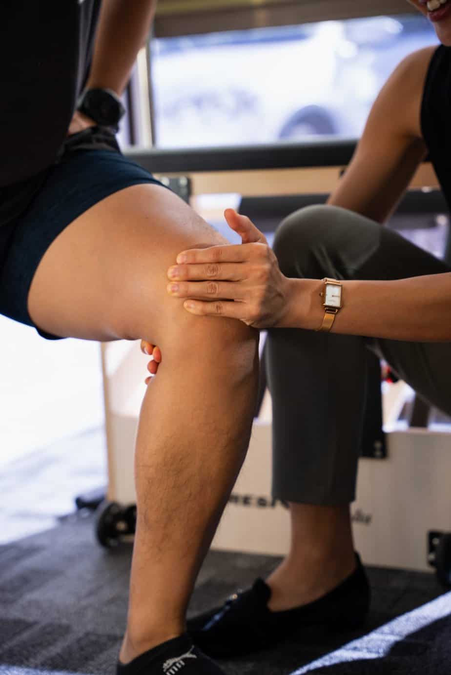 Physiotherapist guiding knee rehabilitation exercise during an appointment