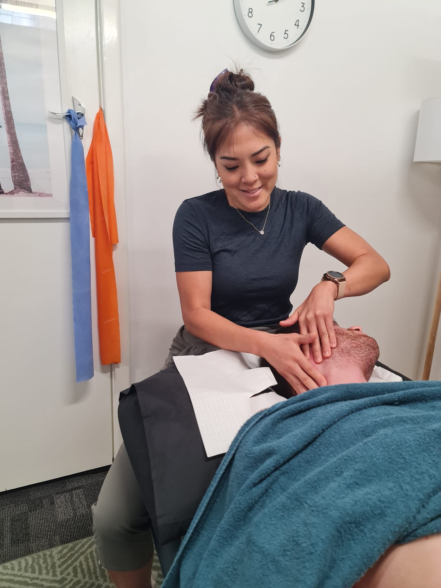 Physiotherapist providing hands-on Vocal Physiotherapy treatment to neck and jaw area in Perth